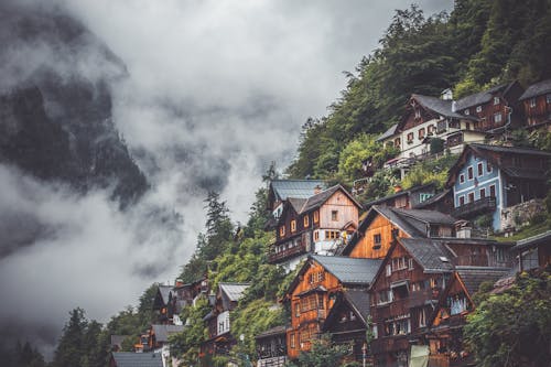 Brown and White Houses Under White Clouds