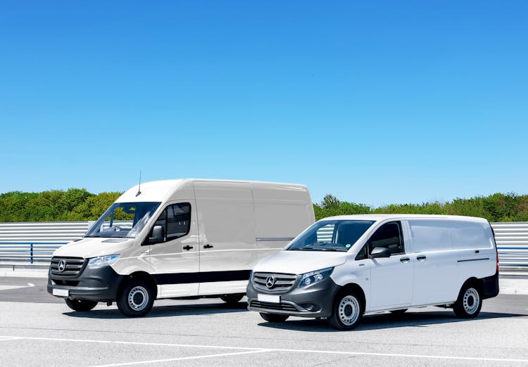 White Vans Parked On Gray Concrete Road