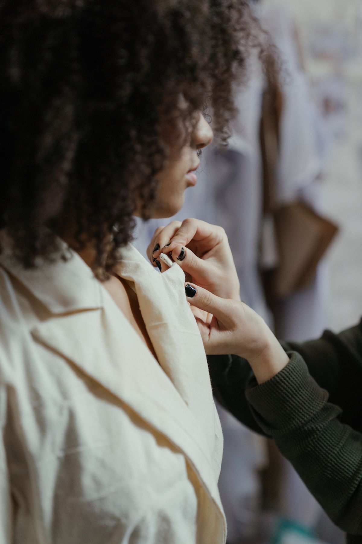 Tailor taking measurements