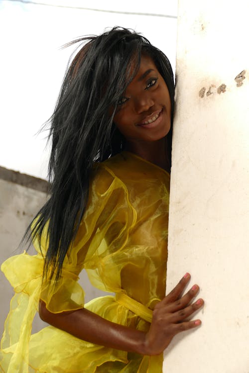 Woman in Yellow Sheer Long Sleeve Dress