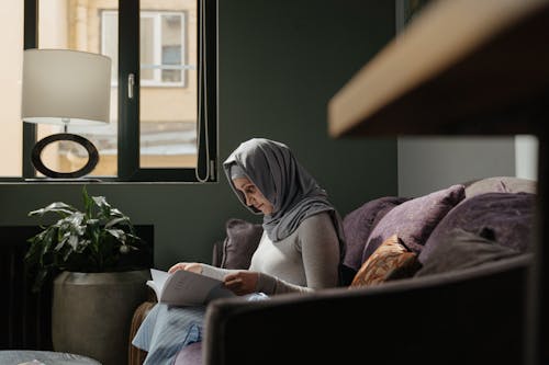 Free Woman in Gray Hijab Reading Book Stock Photo