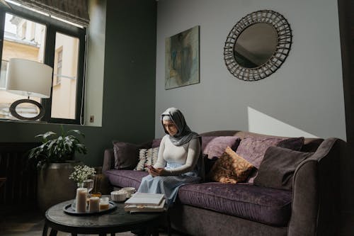 Free Woman in White Hijab Sitting on Brown Sofa Stock Photo