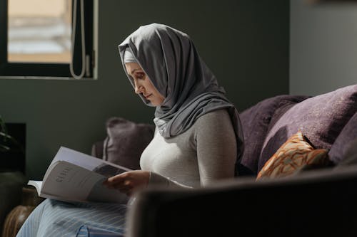 Free Woman in Gray Hijab Reading Book Stock Photo