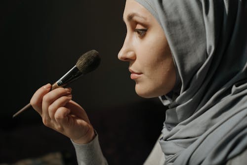 Woman in Gray Hijab Holding Makeup Brush