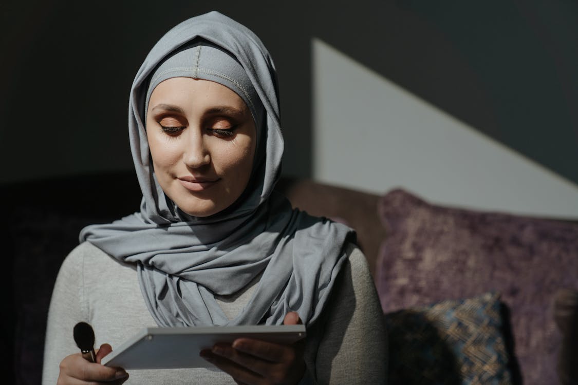Woman in Gray Hijab Holding White Tablet Computer · Free Stock Photo