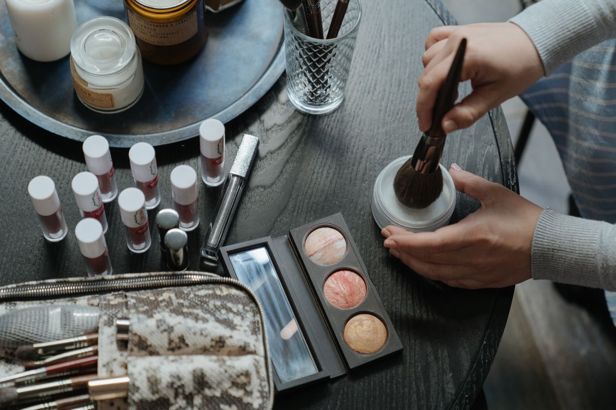 Applying liquid foundation makeup products with professional brush