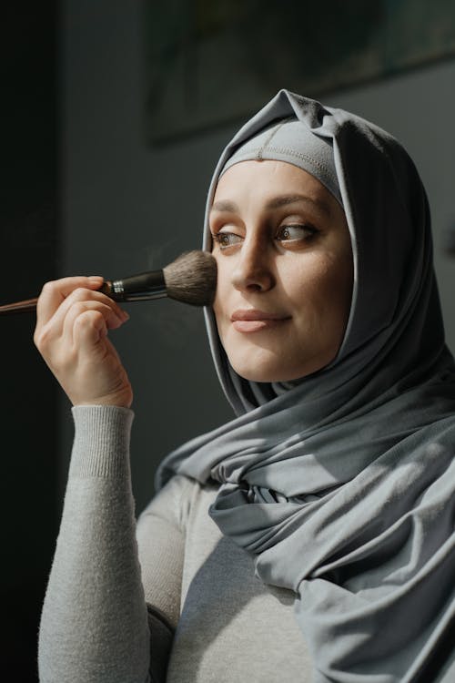 Woman In Grey Hijab Holding Makeup Brush