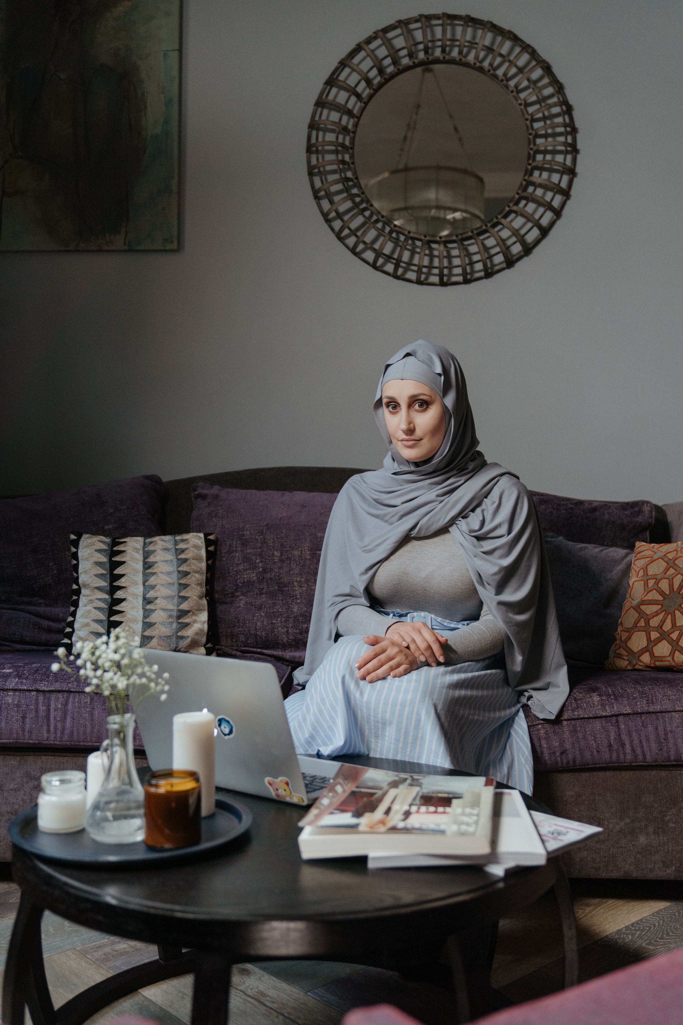Woman in Gray Hijab Sitting on Couch · Free Stock Photo