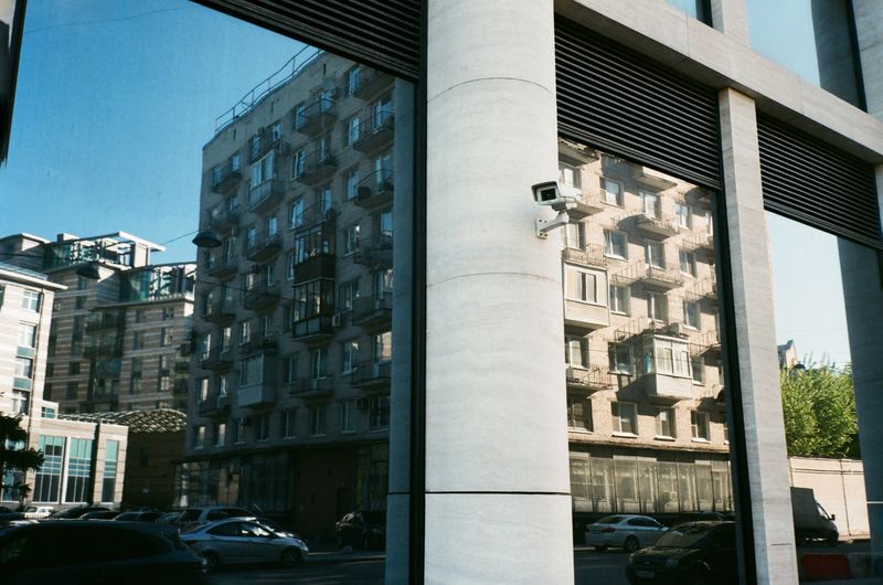 Edificio residencial de varias plantas con una cámara de seguridad instalada en una columna blanca