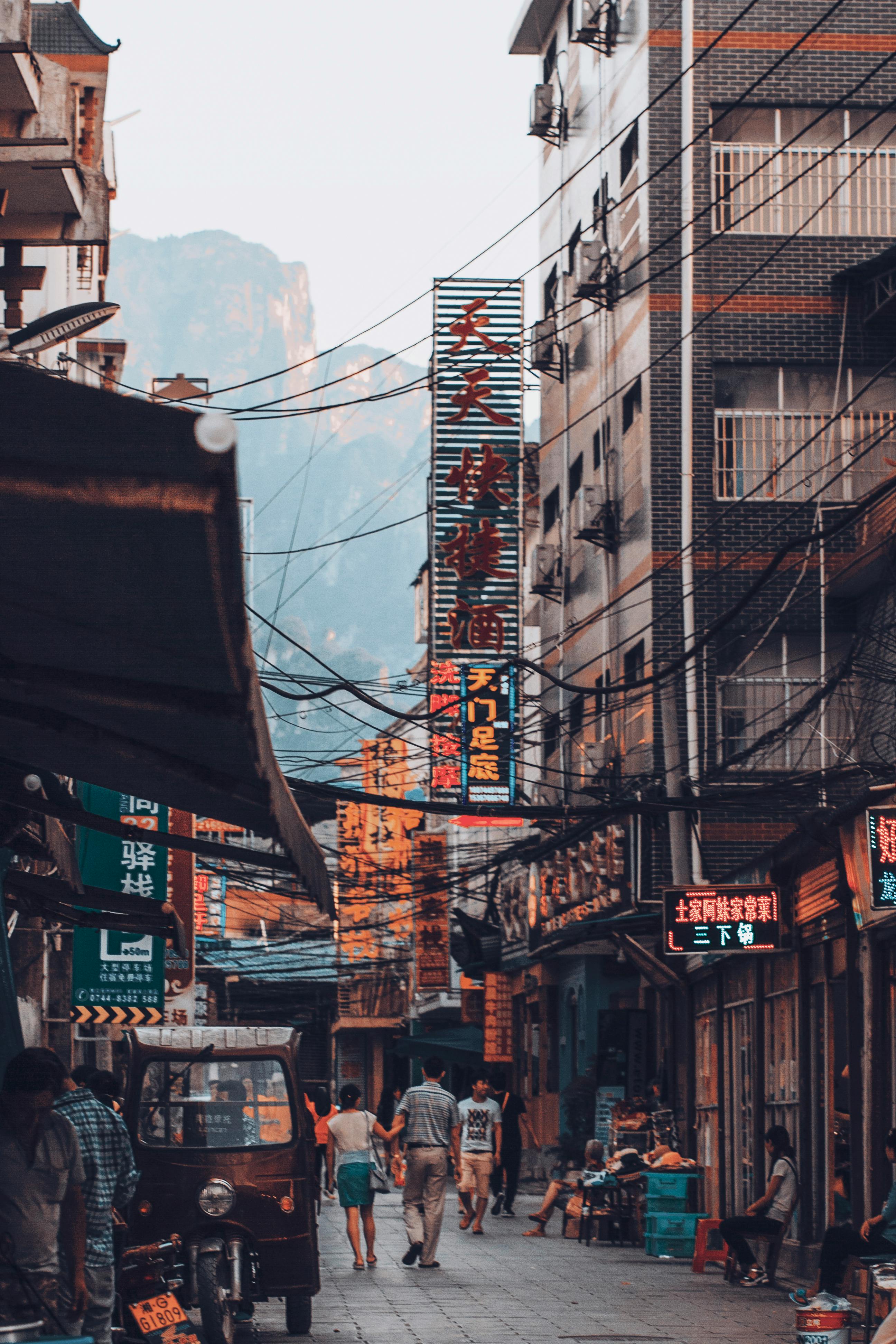 A vibrant street view in Zhangjiajie, China, showcasing local life and architecture.