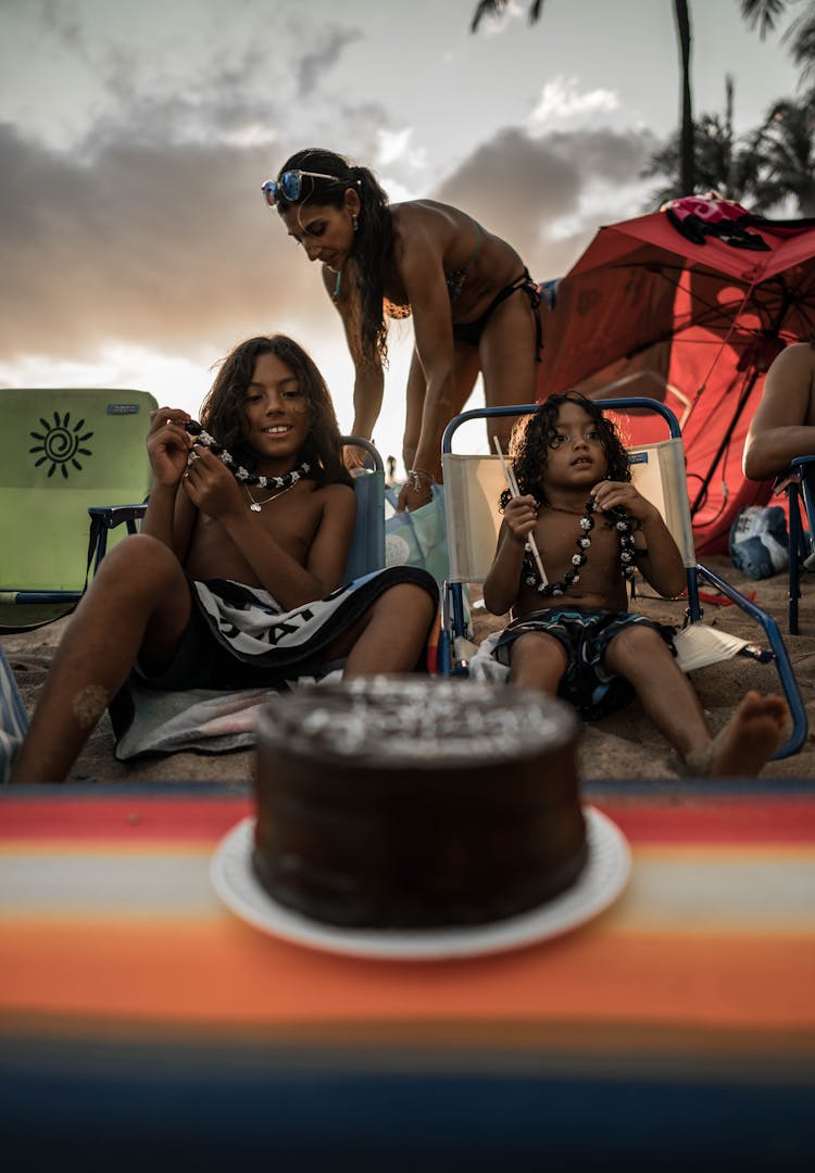 Family Relaxing On Beach