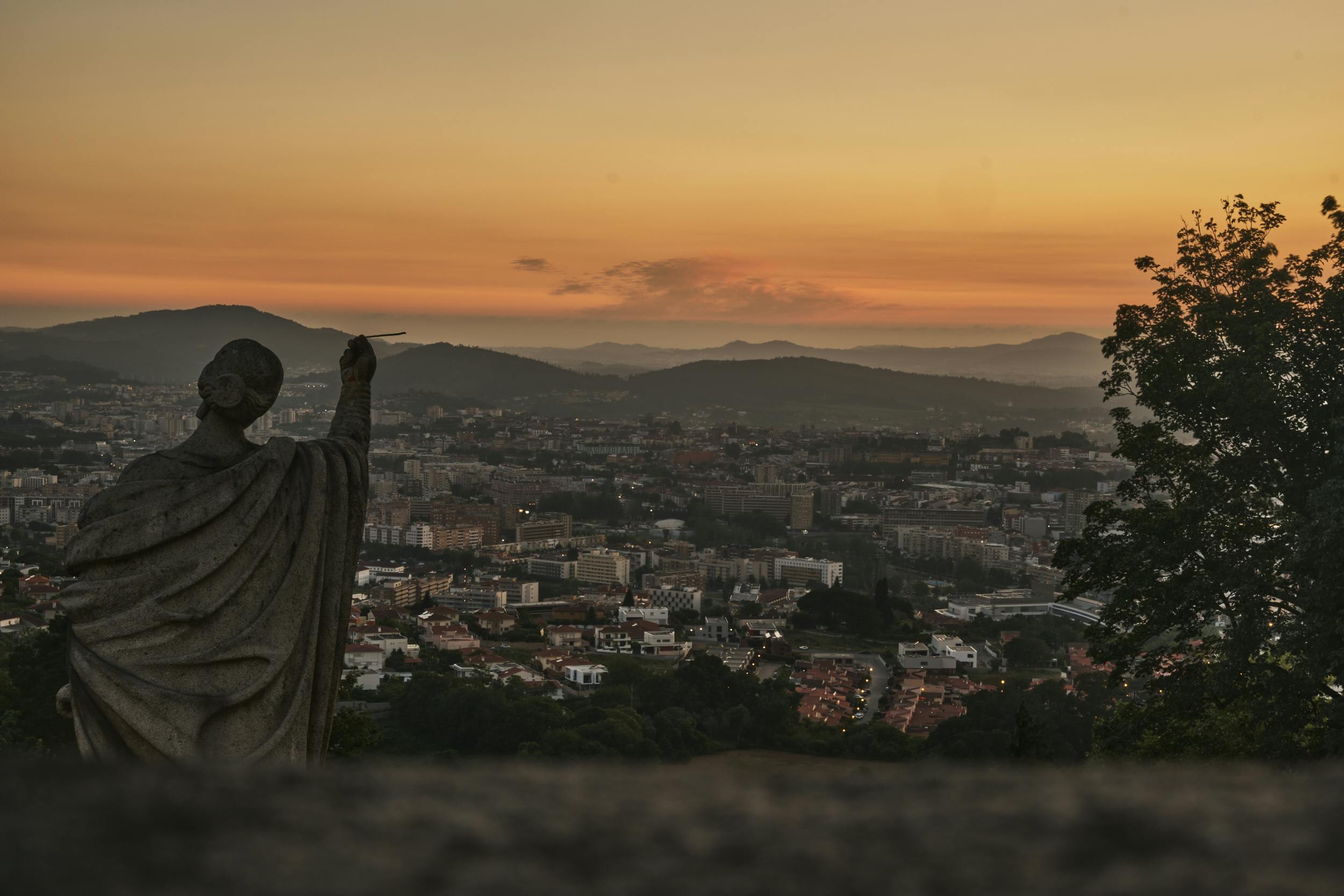 lady figure statue facing city panorama