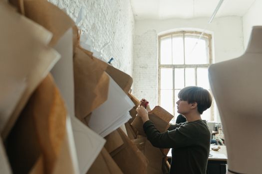 Man in Black Long Sleeve Shirt Holding Brown Cardboard Box