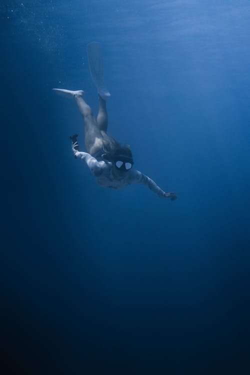 Photo Of Woman Swimming Underwater