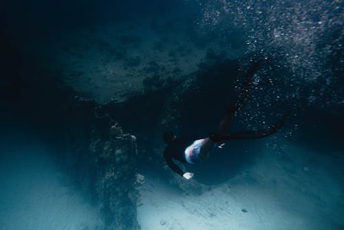 Photo Of Person Swimming Underwater