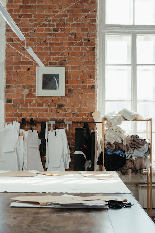 White Textile on Brown Brick Wall