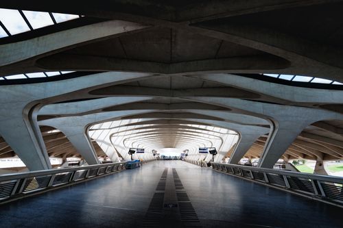 Free Interior view of a futuristic railway station with curved structures and modern design. Stock Photo
