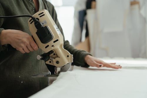 Person Holding Gray and Black Corded Device