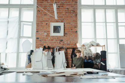 Designer at work in a brick-walled studio — photo by cottonbro studio on Pexels