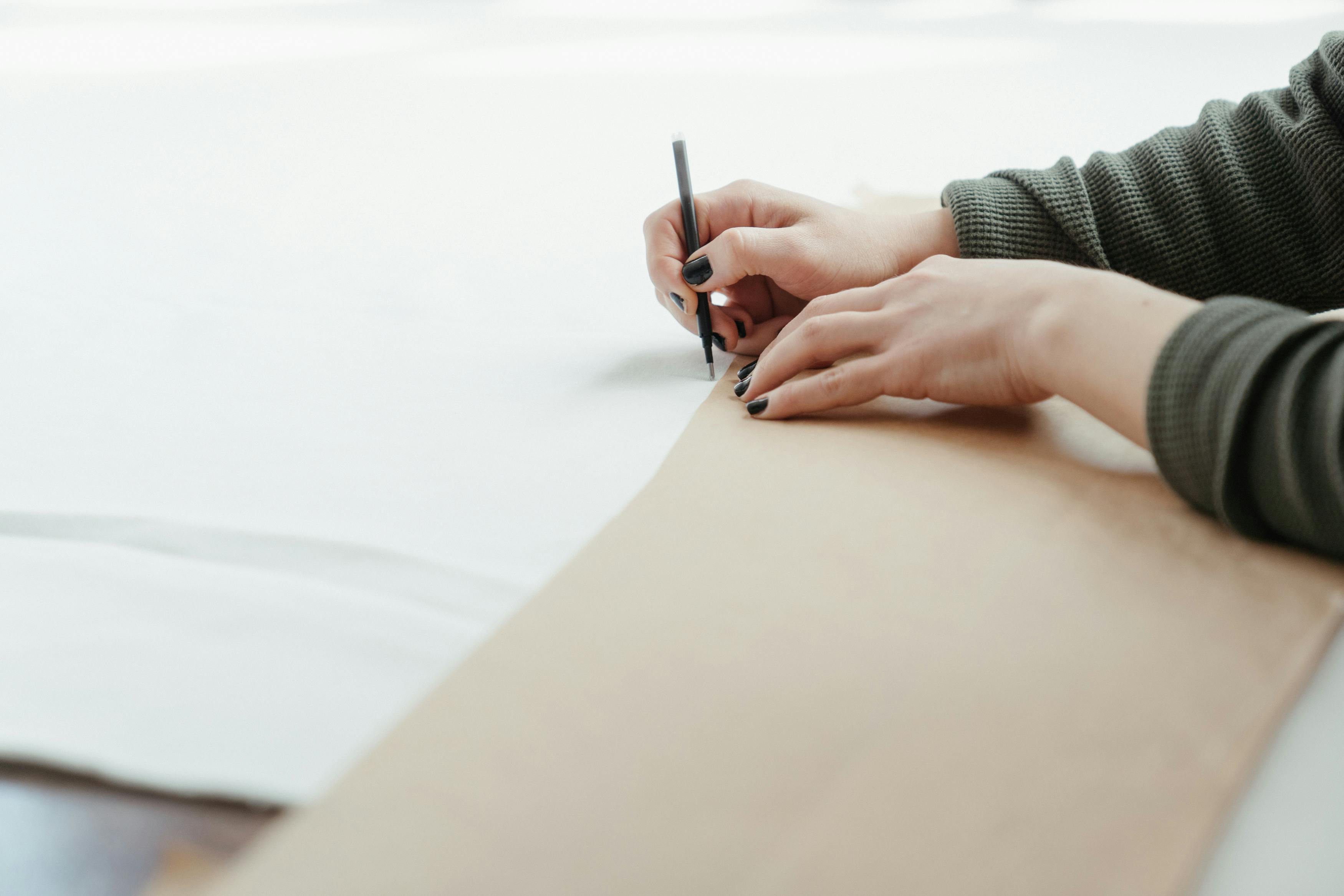 Person Writing on White Paper · Free Stock Photo