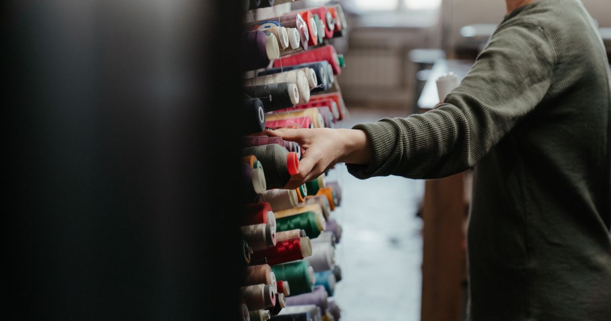 A fashion intern sorting sustainable fabrics at a London design house.