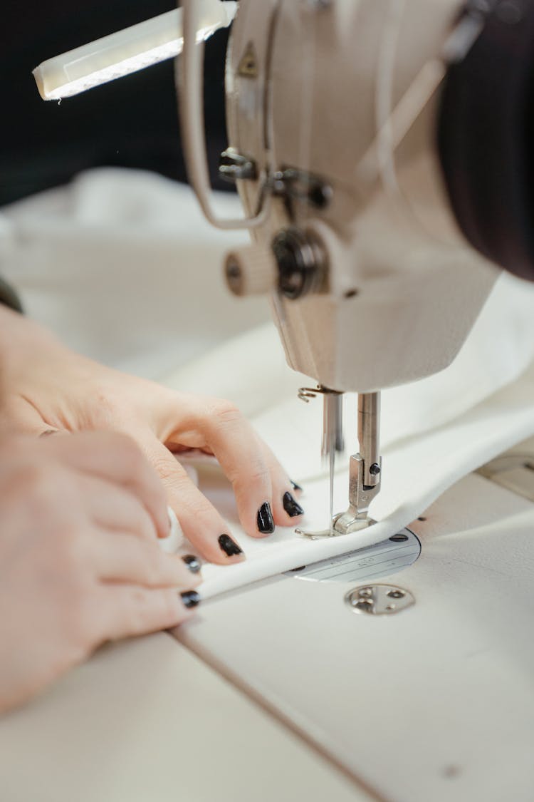 Person Sewing White Sewing Machine