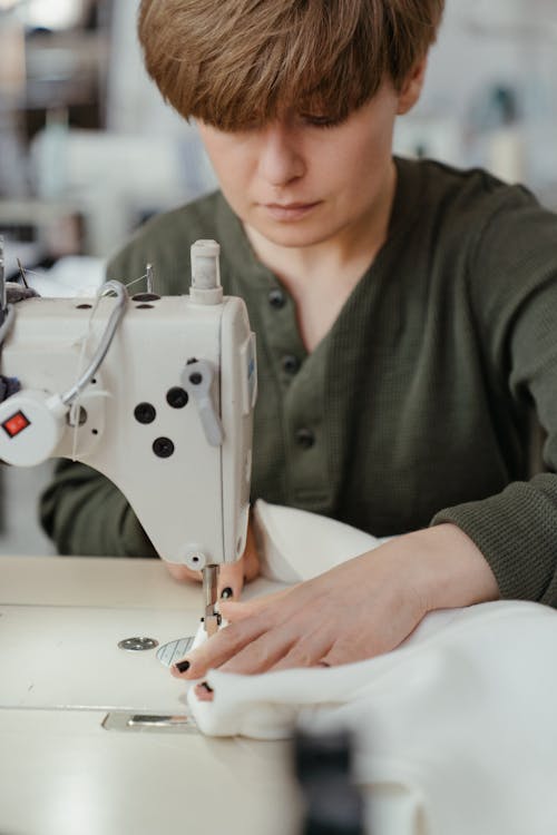 Woman in Green Shirt Sewing