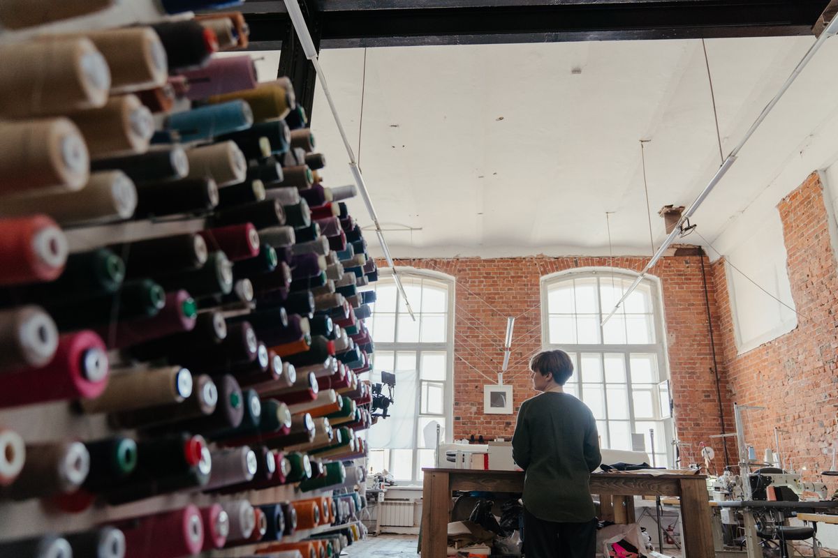 Spools of thread in a workshop with a brick wall interior — photo by cottonbro studio on Pexels