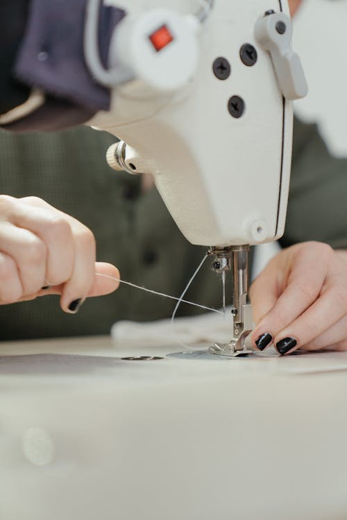 Person Sewing White Sewing Machine