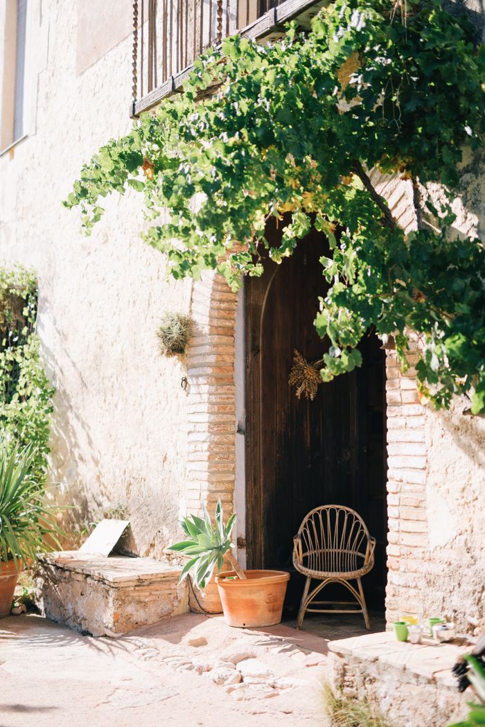 Vine-covered stone entrance with a timber arched door, by Leeloo The First on Pexels