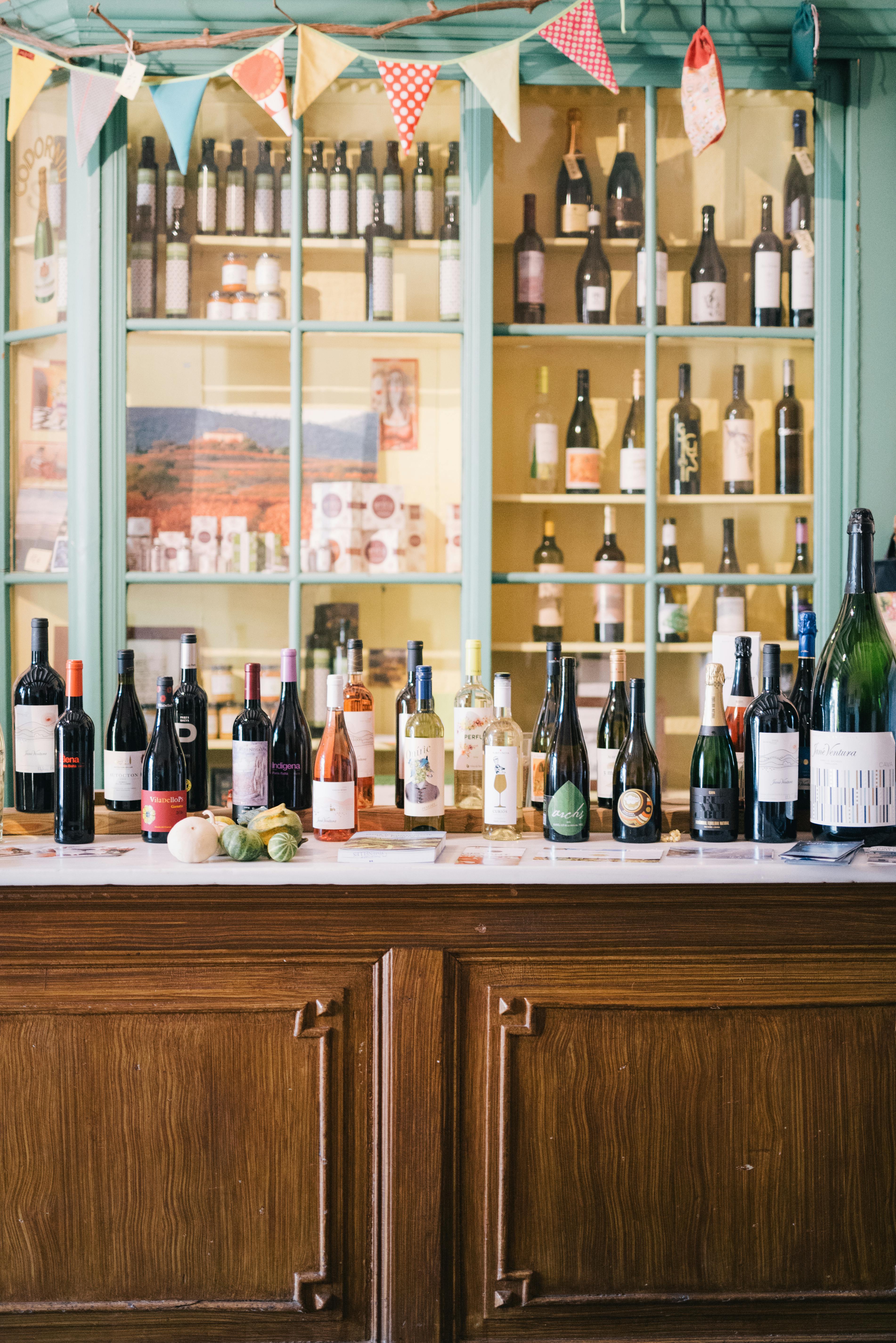 Display of Assorted Wine Bottles on Shelves and Bar Counter