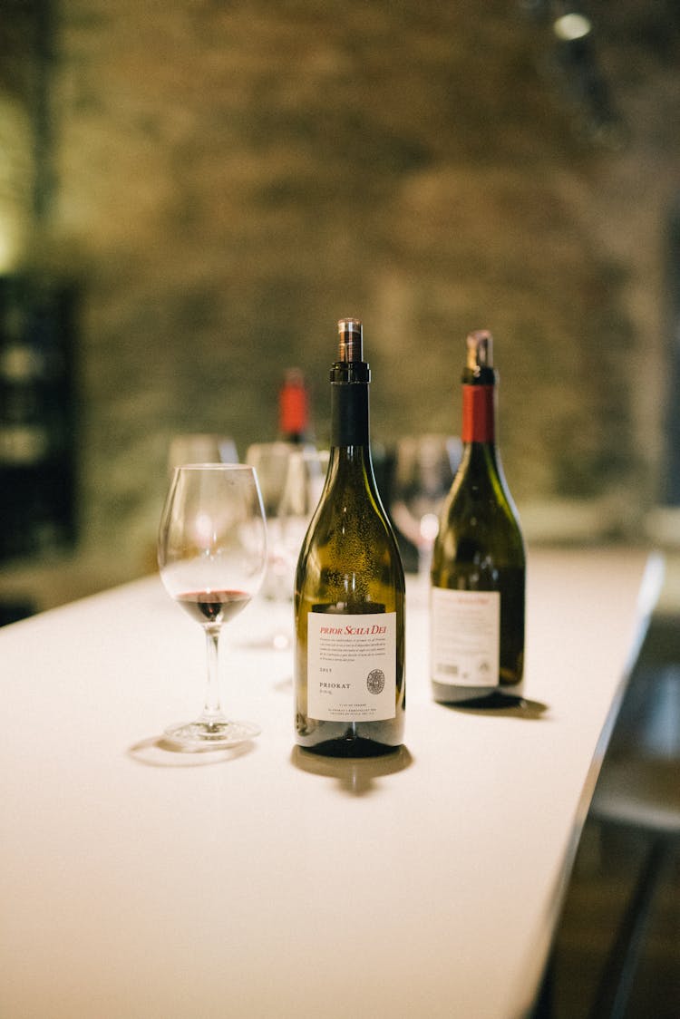 Bottles Of Wine And Wine Glasses On A White Table