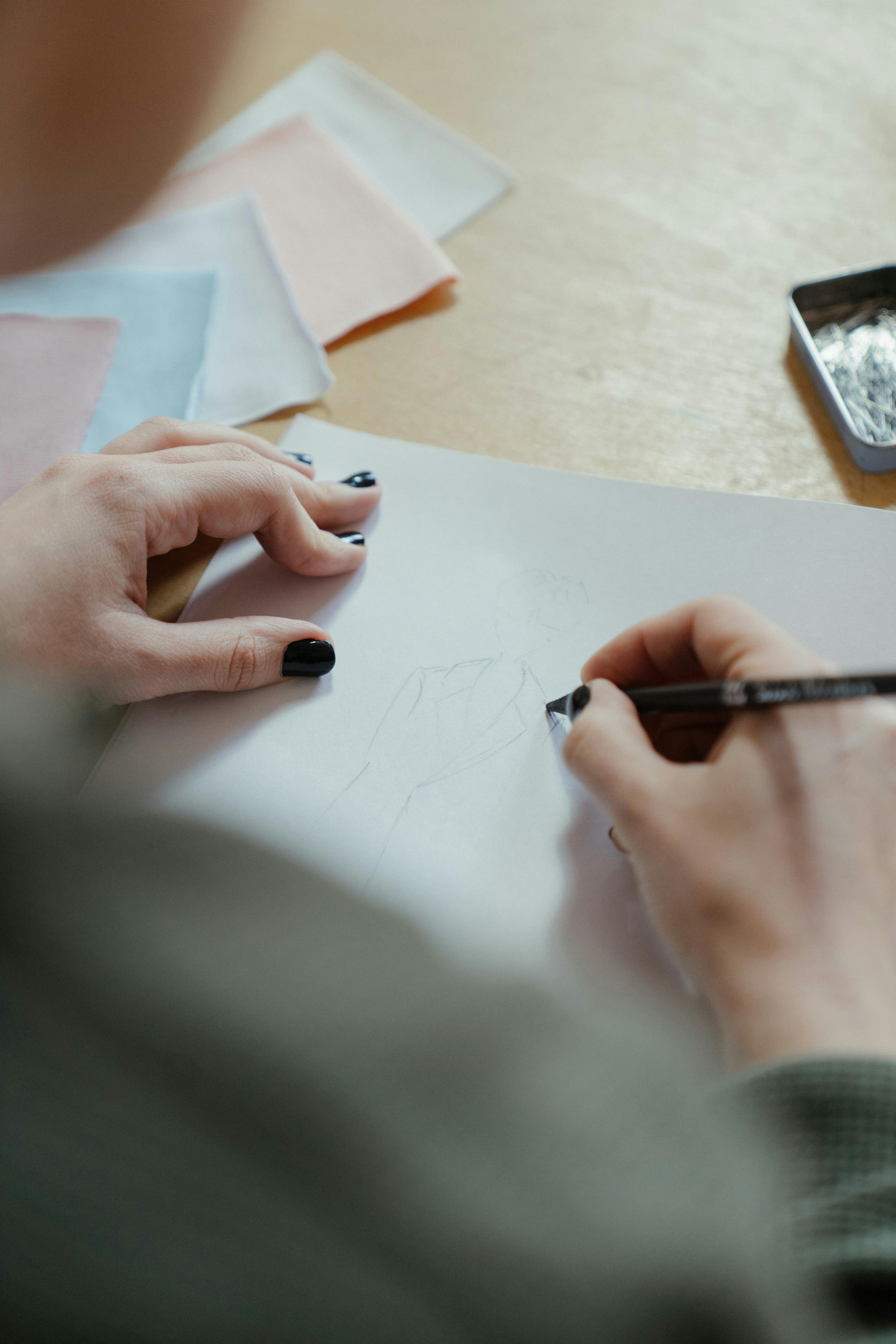 person writing on white paper