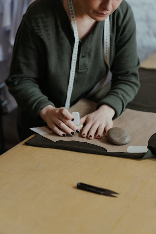 Free Person in Gray Jacket Writing on White Paper Stock Photo