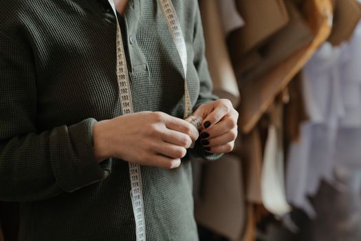 Man in Black and Gray Pinstripe Dress Shirt Holding Silver and Black Belt