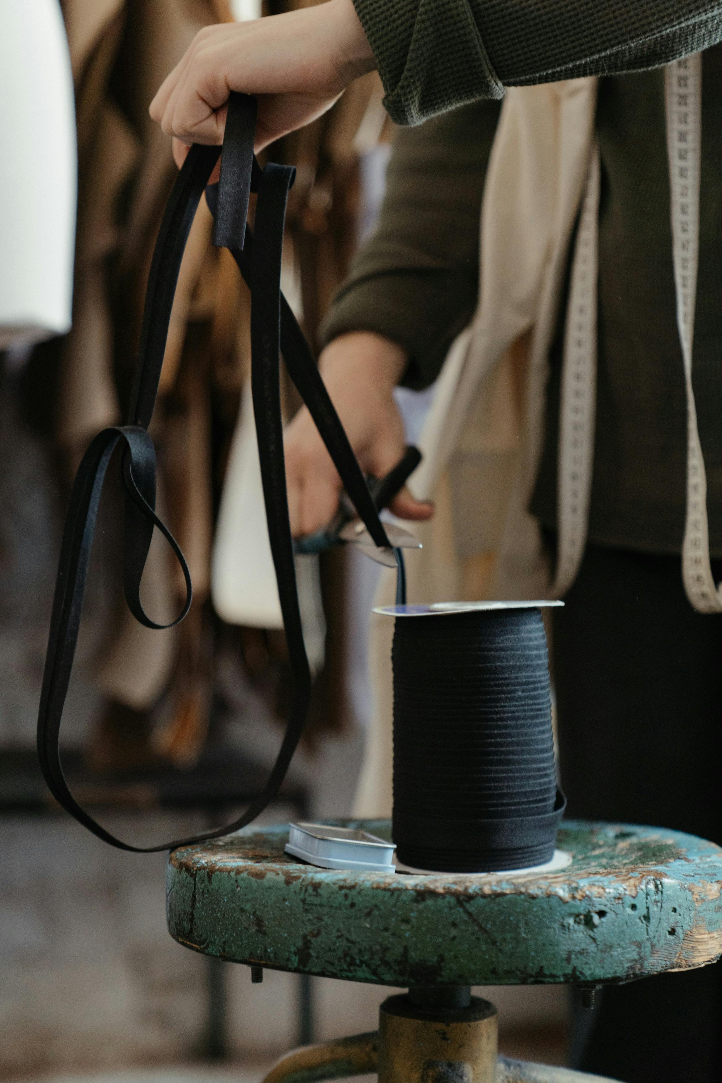 Black Leather Sling Bag on Blue and White Ceramic Mug \u00b7 Free Stock Photo