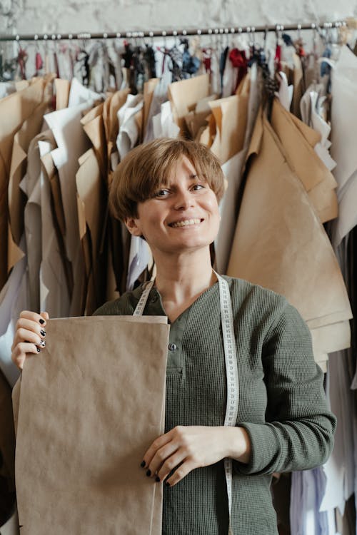 Woman in Gray Sweater Holding Brown Paper Bag