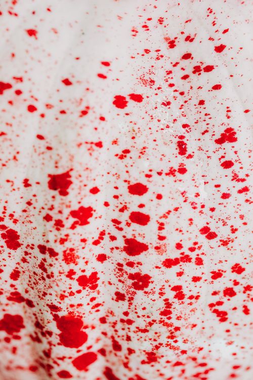 Free Vivid red splashes create a striking abstract pattern on a white background, ideal for creative projects. Stock Photo