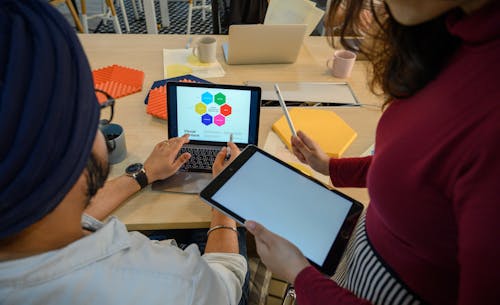 Man and Woman Using Technology in the Office