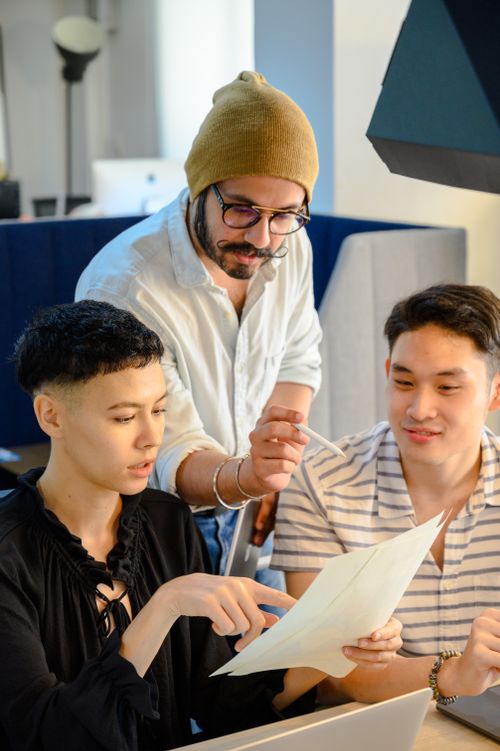 Free Group of diverse adults collaborating in a modern office environment. Stock Photo