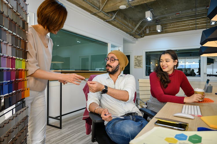 Woman Handing Card To A Man Bearded Sitting 