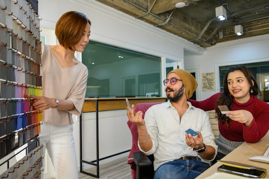 A diverse team discussing color samples for a project in a modern office setting.