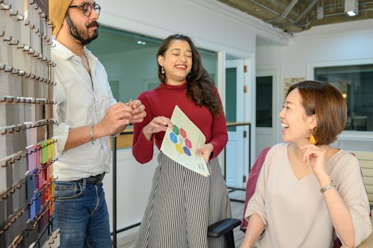 Smiling group discussing project ideas in a modern office setting, fostering teamwork.