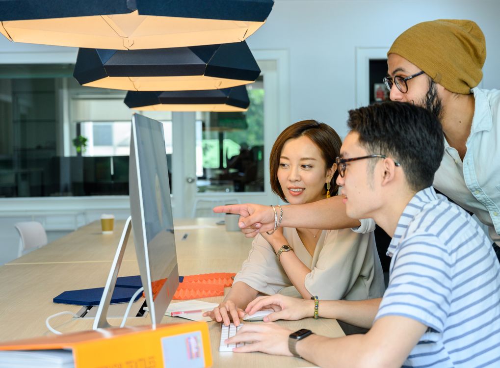 Big Person Using Small Computer Screen People Looking at the Computer Monitor · Free Stock Photo