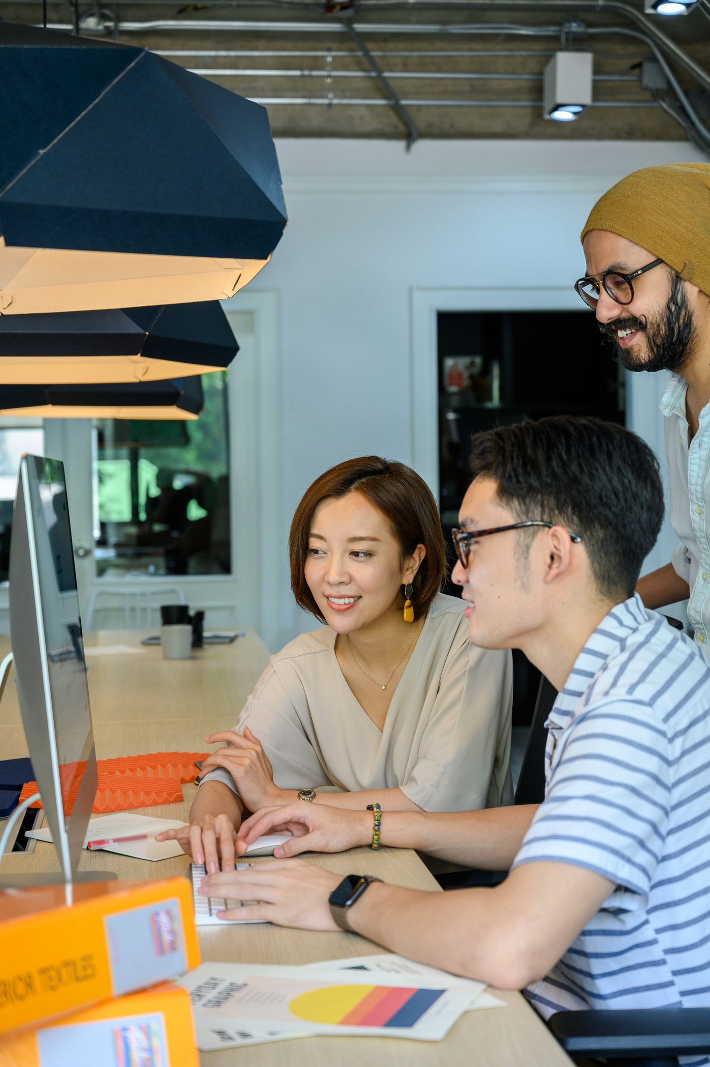 Design team at a desk reviewing packaging