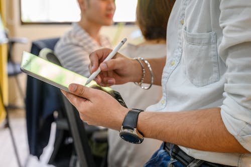 Person Writing on an Ipad Using Apple Pencil 