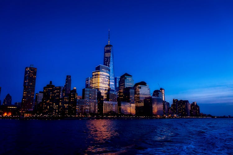 Photo Of City Buildings Near Body Of Water