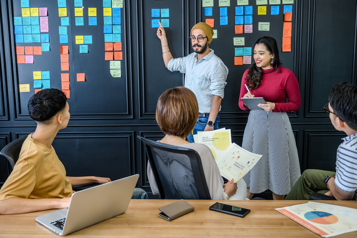 Innovation team brainstorming with sticky notes and sprint planning artifacts