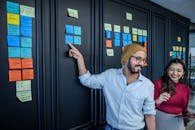 A Man in Brown Beanie Pointing the Sticky Notes