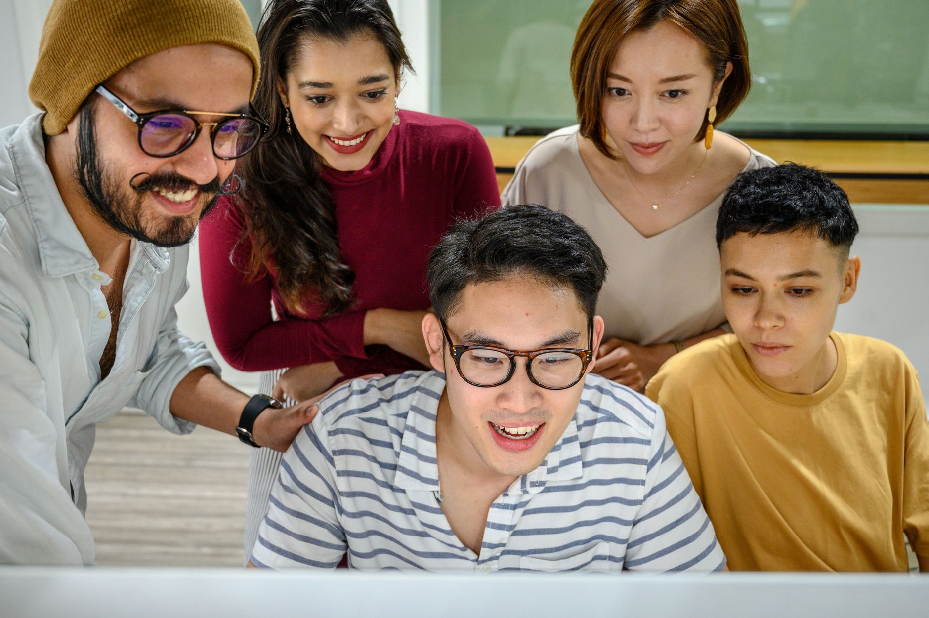 A group of diverse professionals engaging in a collaborative office meeting.